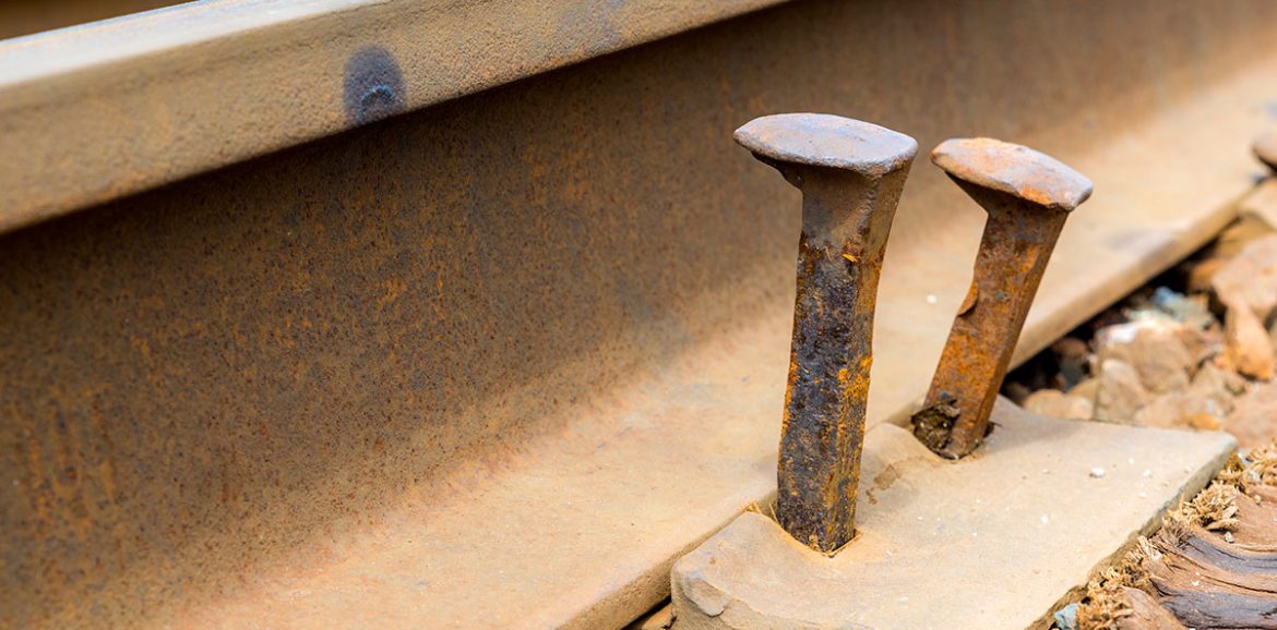 A close up of two railroad nails