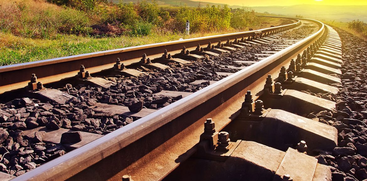 An image of train tracks at sunset