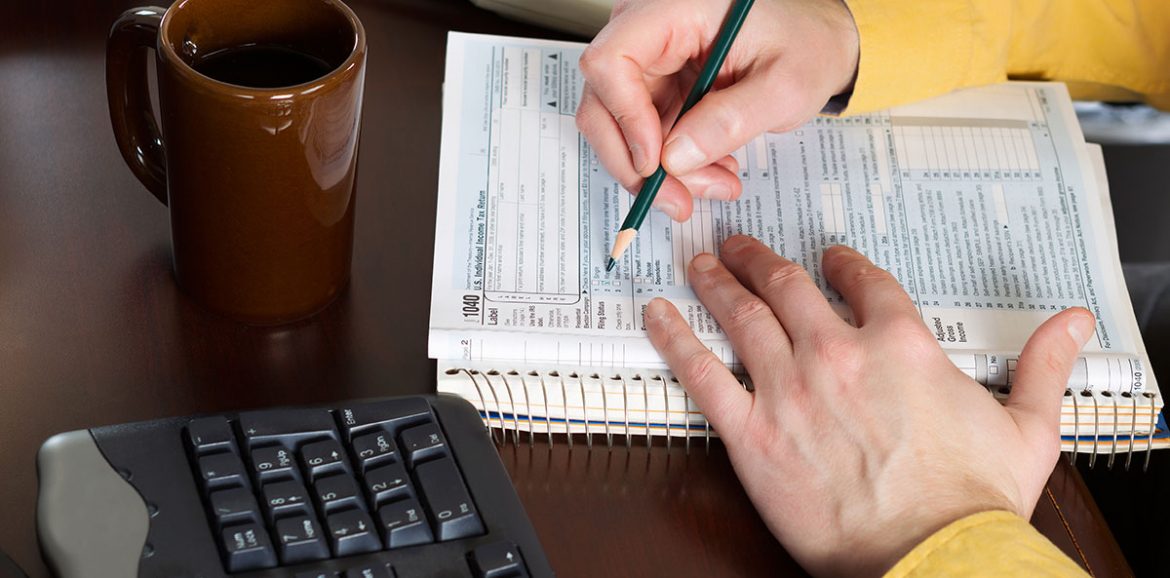 An accountant working on a 1040 tax form